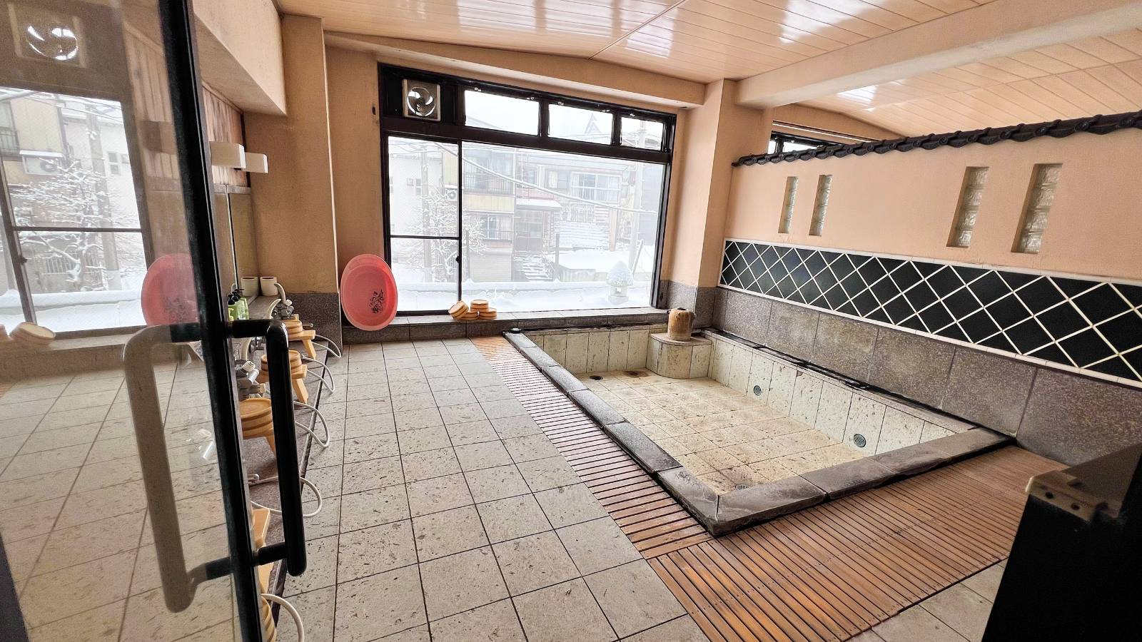 Large onsen bath filled with natural hotspring water.